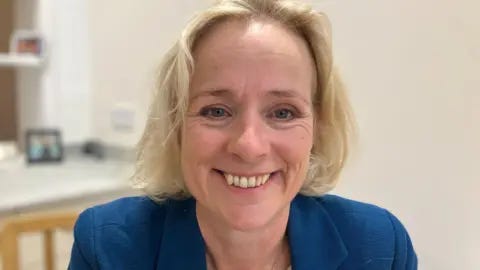 Andrew Sinclair/BBC A head-and-shoulders picture of Vicky Ford, the former MP for Chelmsford. She has shoulder-length blonde hair and is smiling at the camera. She is wearing a blue jacket.