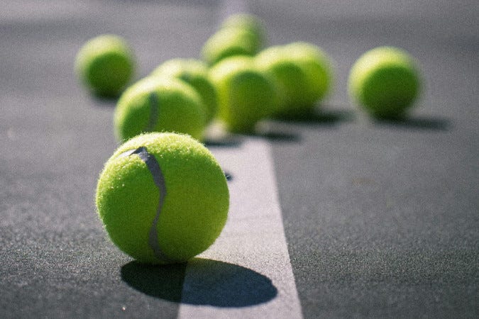 Tennis balls on a tennis court.