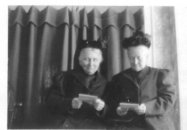 Two women reading letters