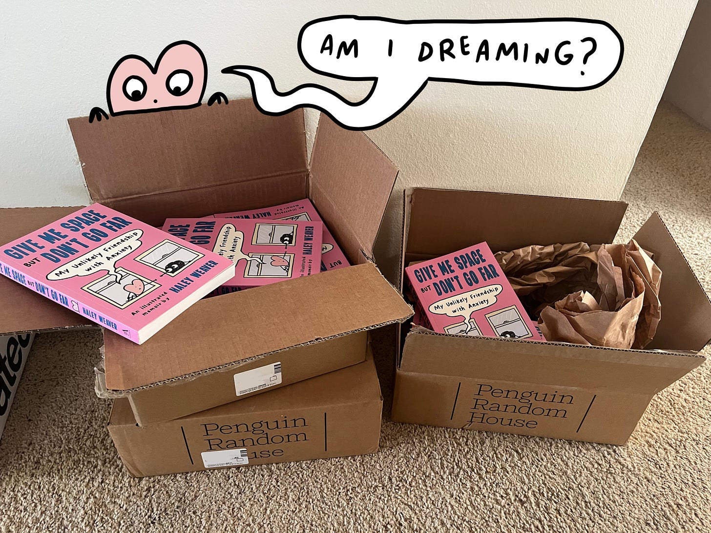 Box of books, with a heart peering over, saying "am I dreaming?"