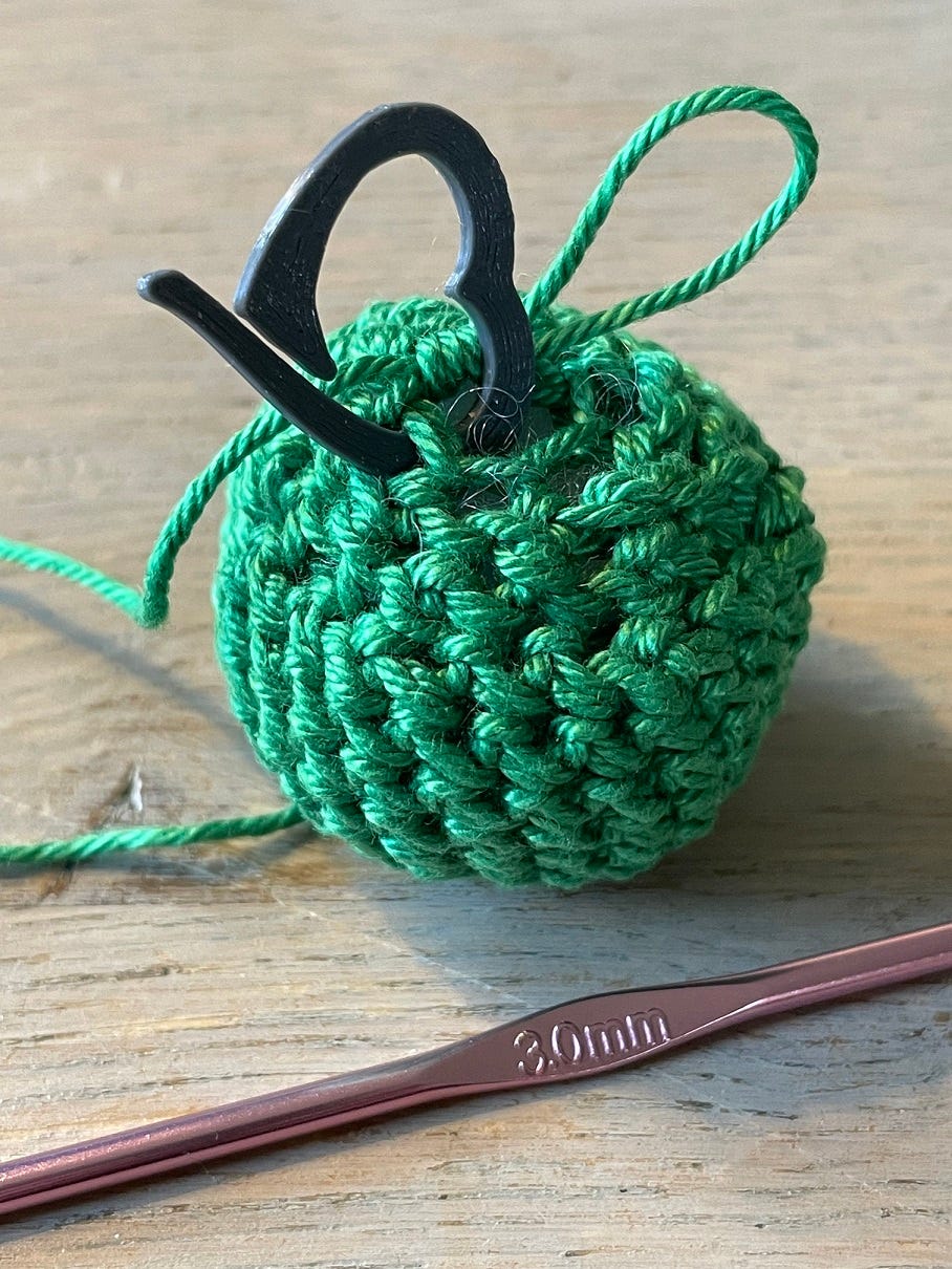 Photo: Crochet round body of an elf in green yarn