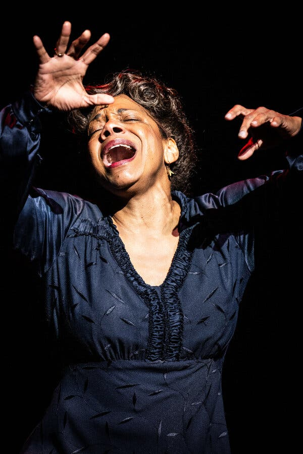McDonald sings with passion, her eyes closed and her arms raised.