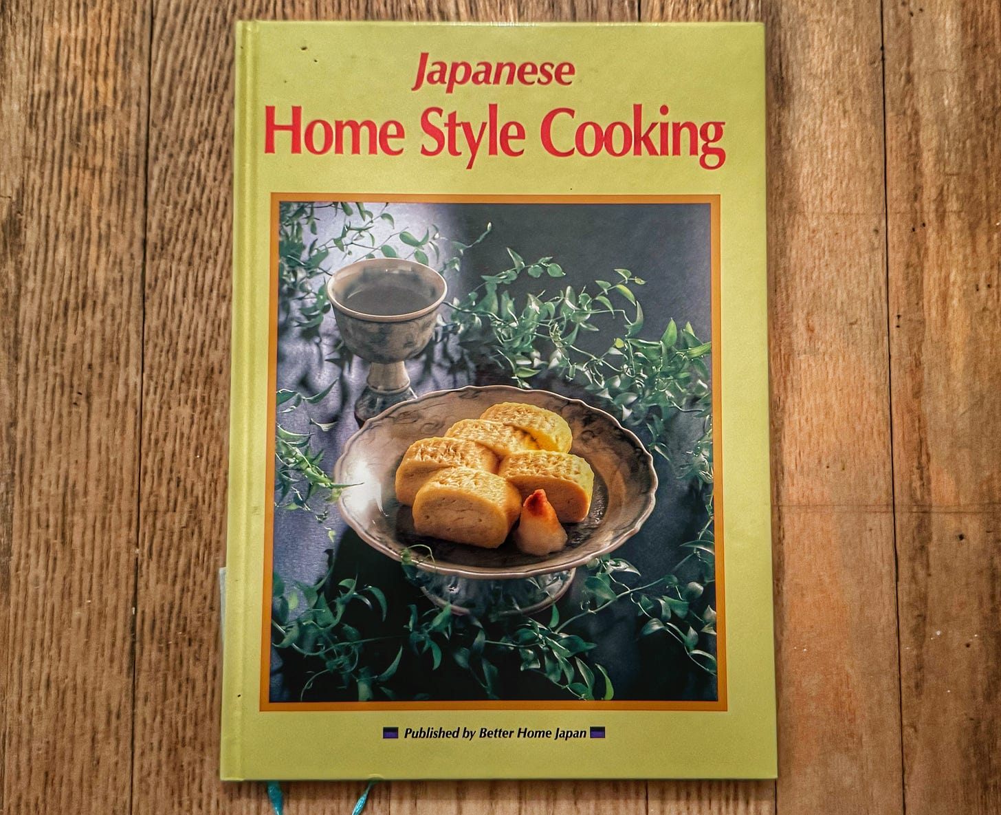 A copy of "Japanese Home Style Cooking," showing a dish with rolled-egg tamago.
