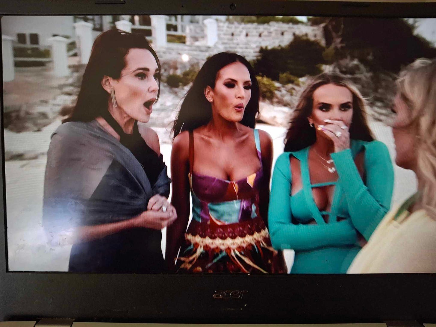 The cast of Real Housewives of Salt Lake City on a beach in gowns looking surprised
