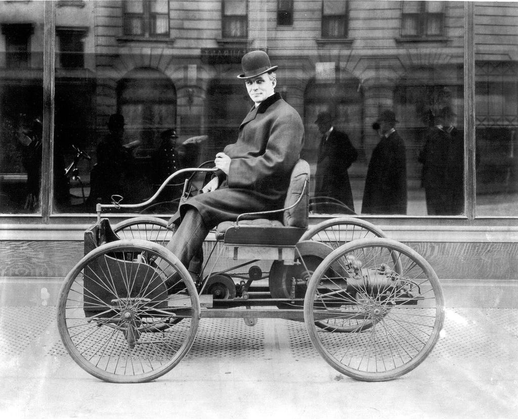 Henry Ford sitting in his first automobile, the Quadricycle in 1896.