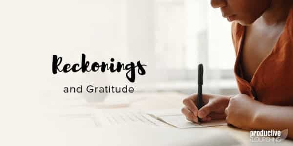 Black woman writing in a journal. Text overlay: Reckonings and Gratitude