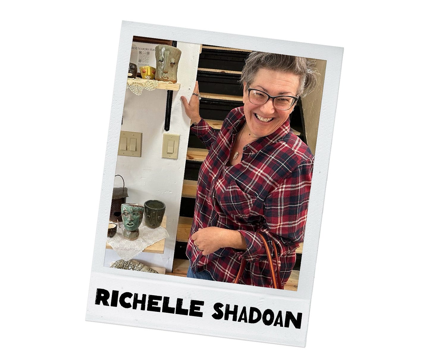 Richelle Shadoan smiles in front of shelves of her pottery - vases with faces. She is wearing a plaid flannel shirt.