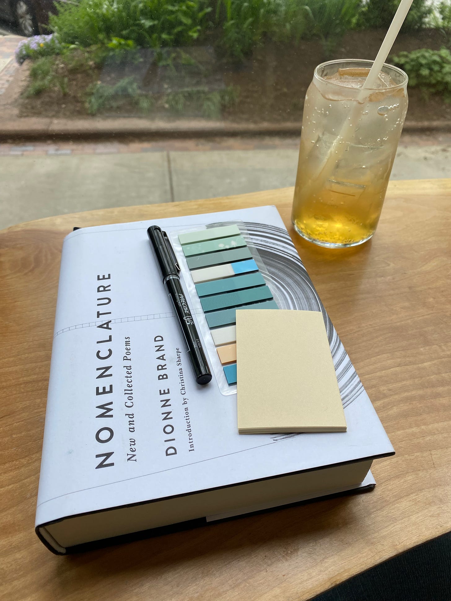 Nomenclature on a cafe table next to a glass of house-made fennel soda.