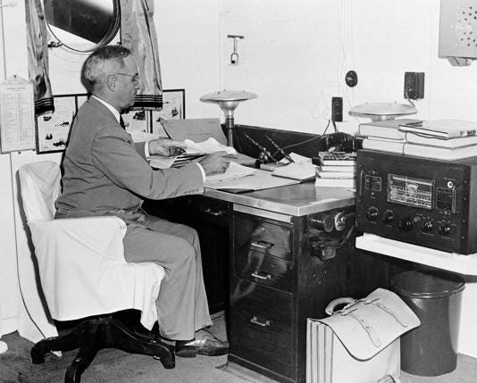 In this Aug. 6, 1945, file photo, aboard the cruiser Augusta, President Harry S. Truman, with a radio at hand, reads reports of the first atomic bomb raid on Japan, while en route home from the Potsdam conference.