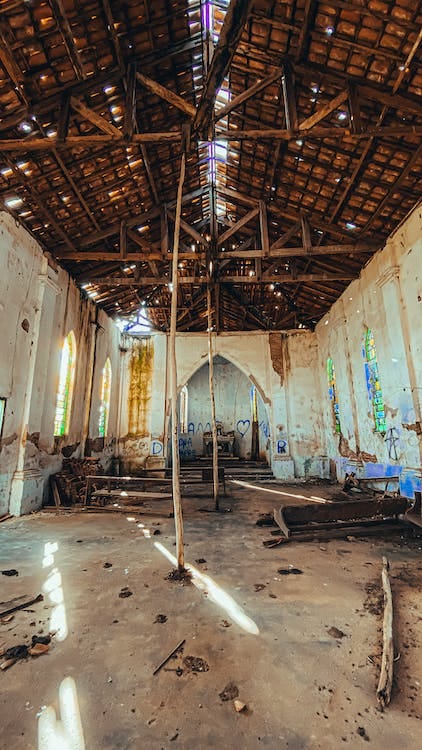 Inside an abandoned cathedral in a state of disrepair and vandalism