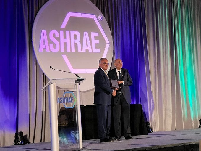Image final COVID czar ashish jha unmasked on stage accepting an award from ASHRAE