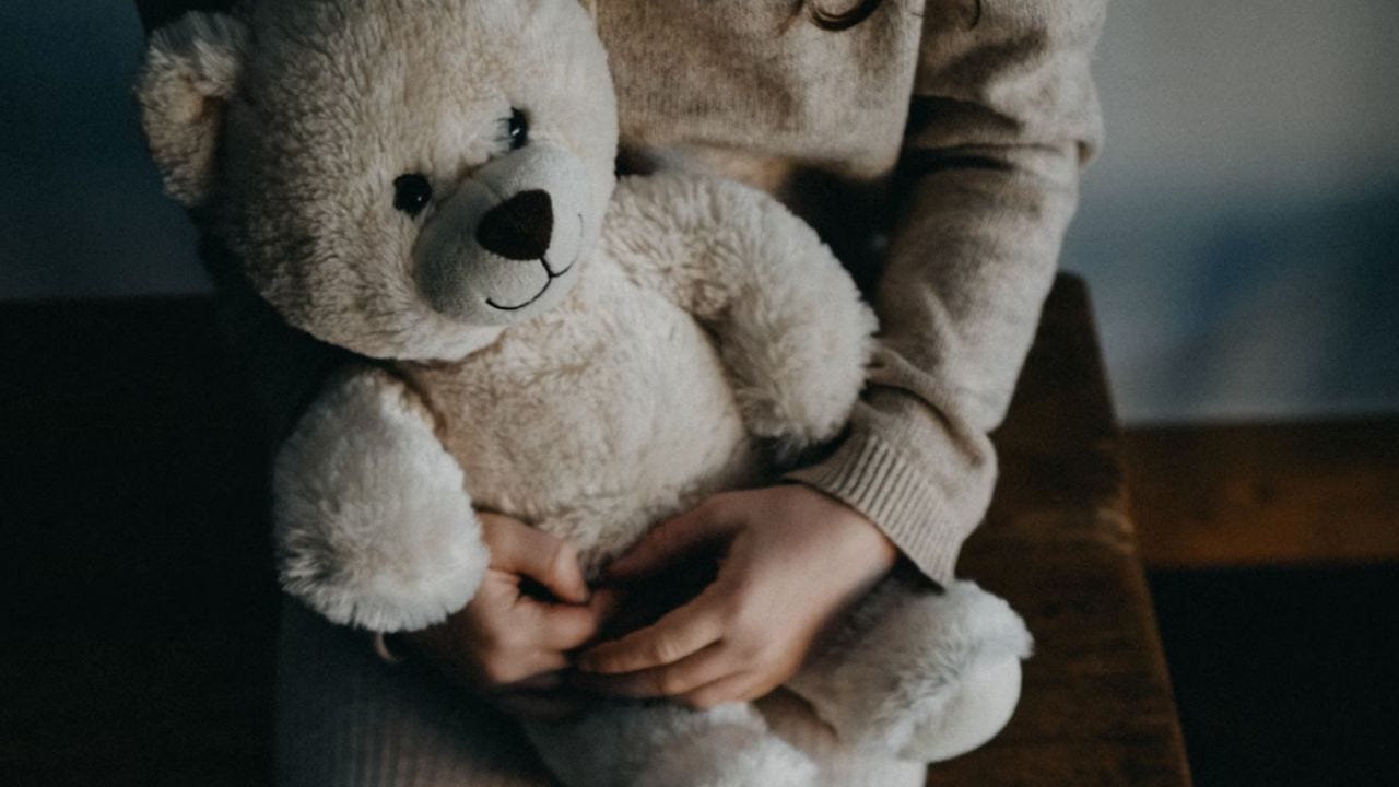 Girl holding bear by Annie Spratt on unsplash