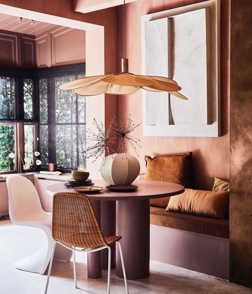 dining room space using warm tones and a focal lightshade above the table