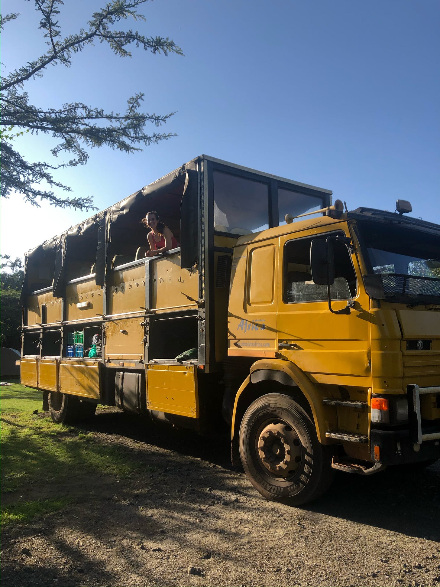 girl on a big yellow truck in Kenya