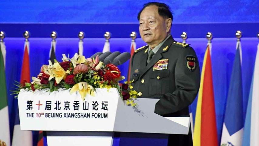 A person in military uniform standing at a podium

Description automatically generated