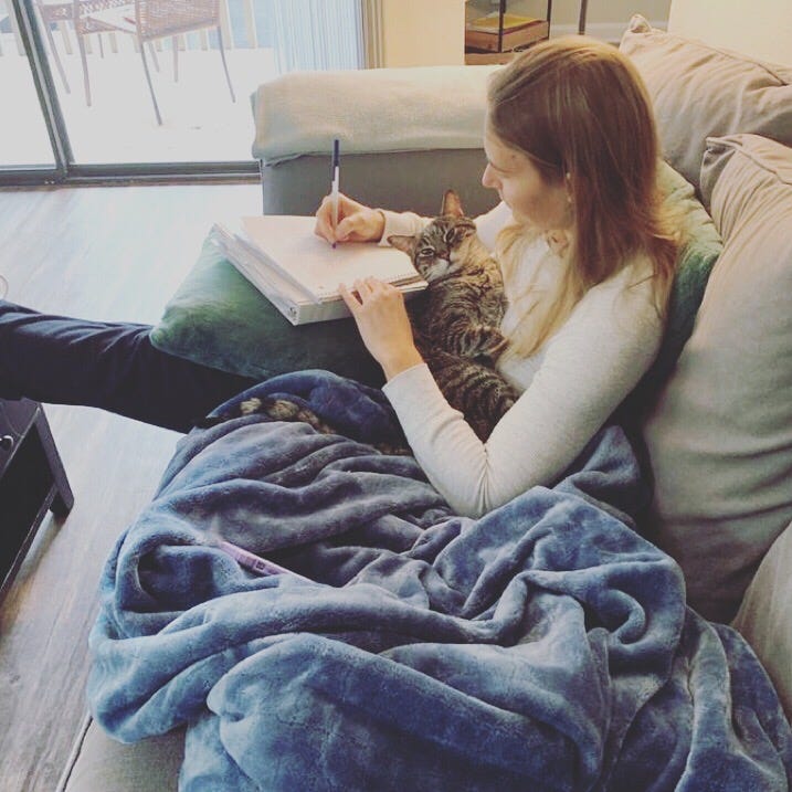 picture of cat and women writing