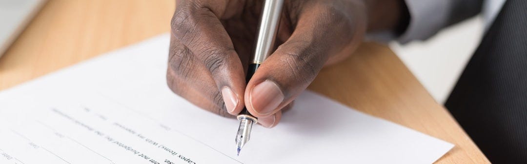 person writing on white paper person writing on white paper