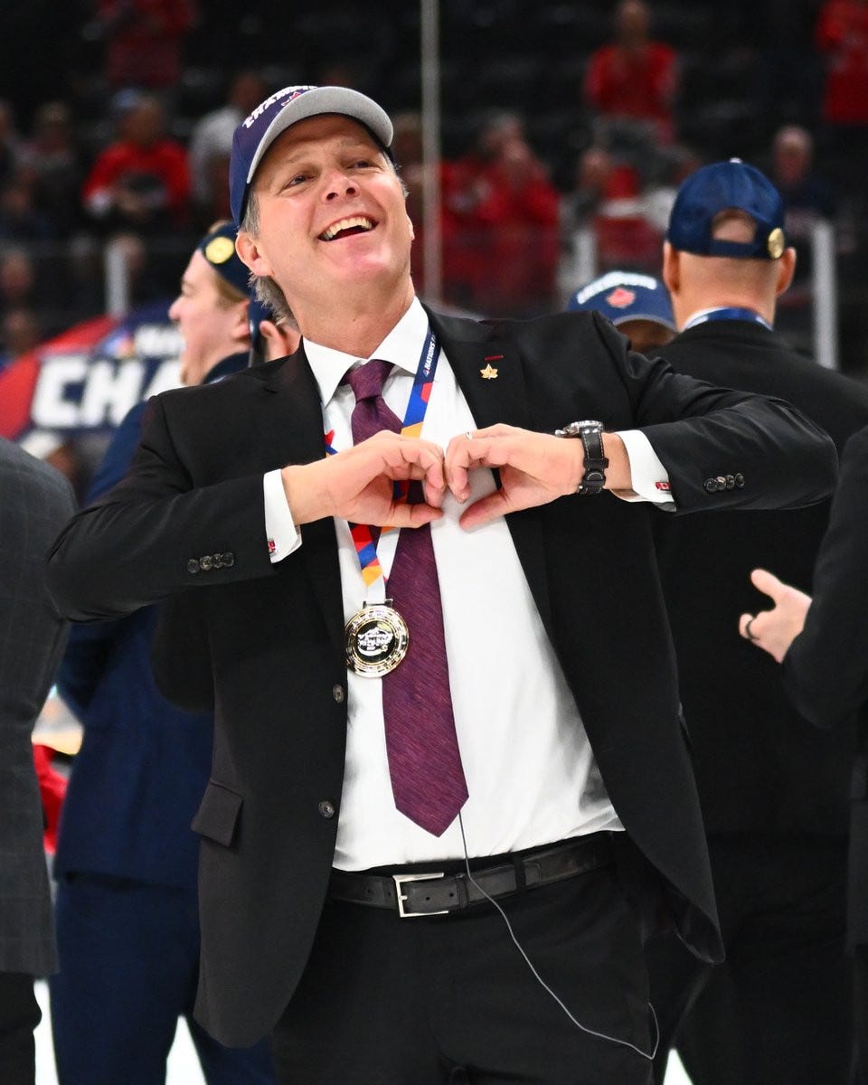 Jon Cooper making a heart sign with his hands on ice after the game.