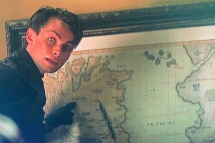 Freddy Carter as Kaz Brekker pointing frantically at a map