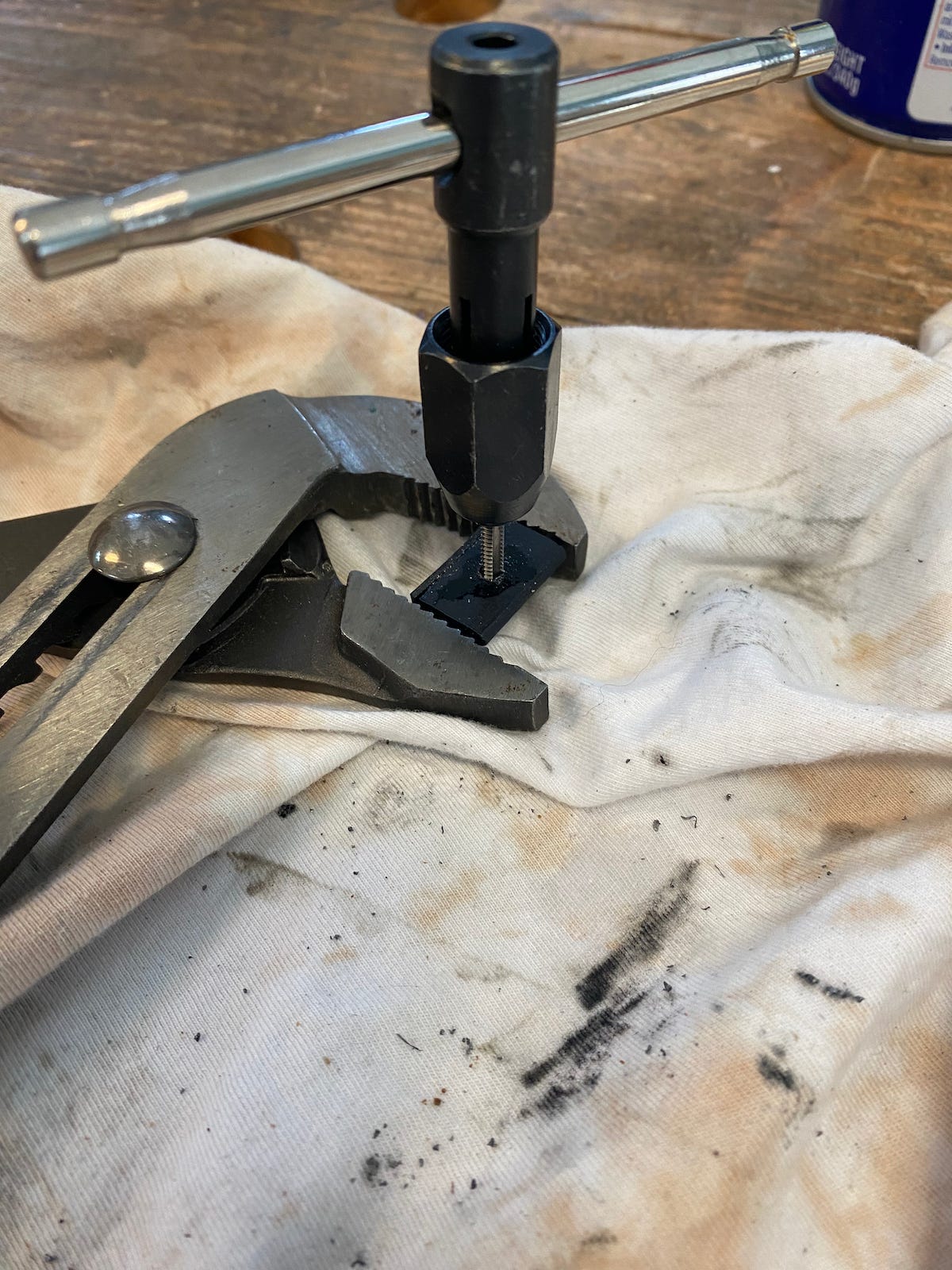 Holding the clip with a wrench, I carefully hand-tapped the hole to create threads. Once I learned how to tap properly, it worked like a charm.