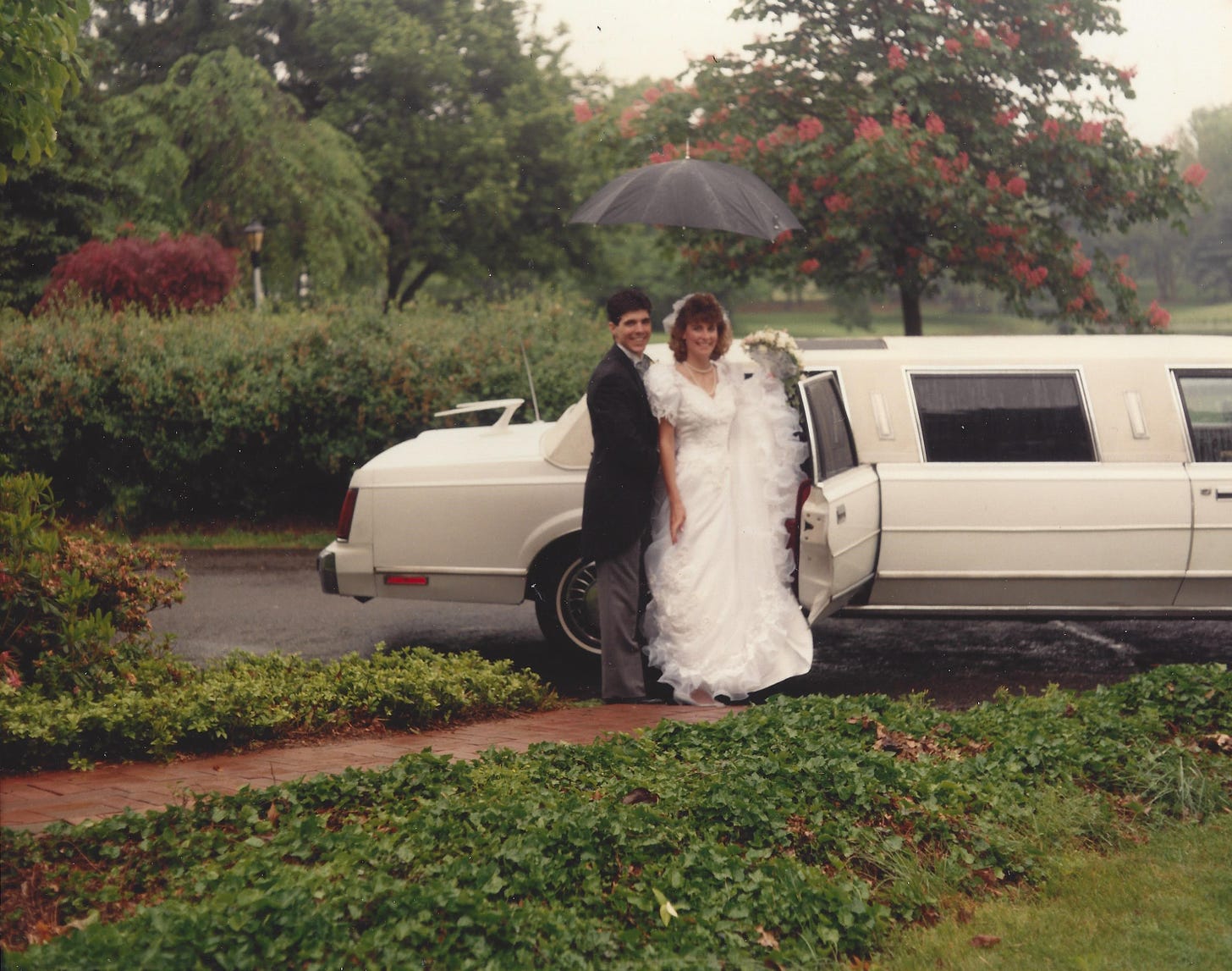 Young couple on their wedding day about to get into a limo