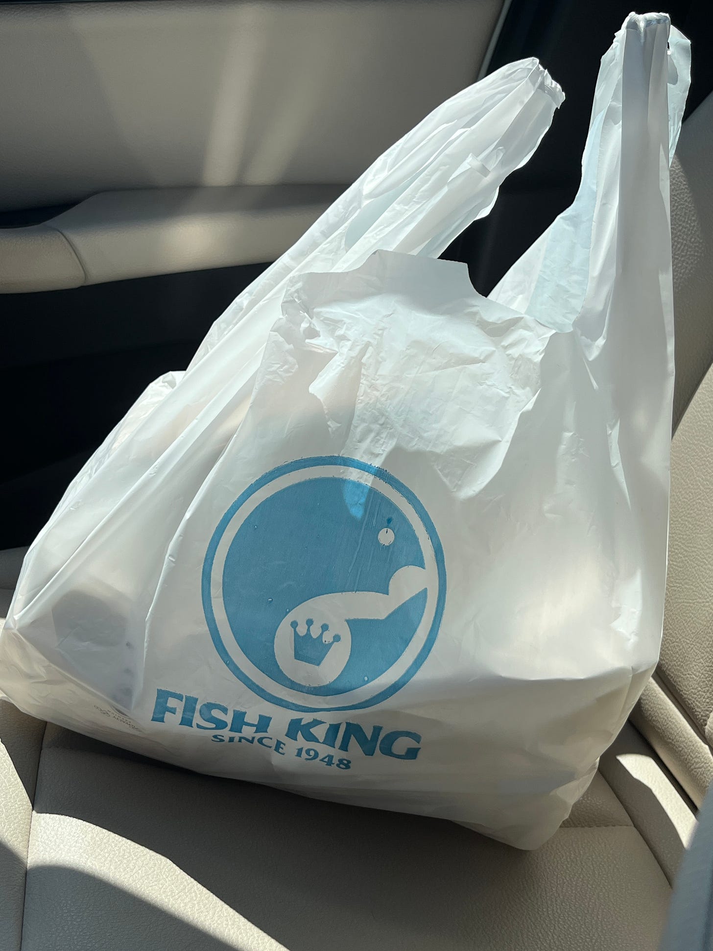 A Fish King plastic takeaway bag.