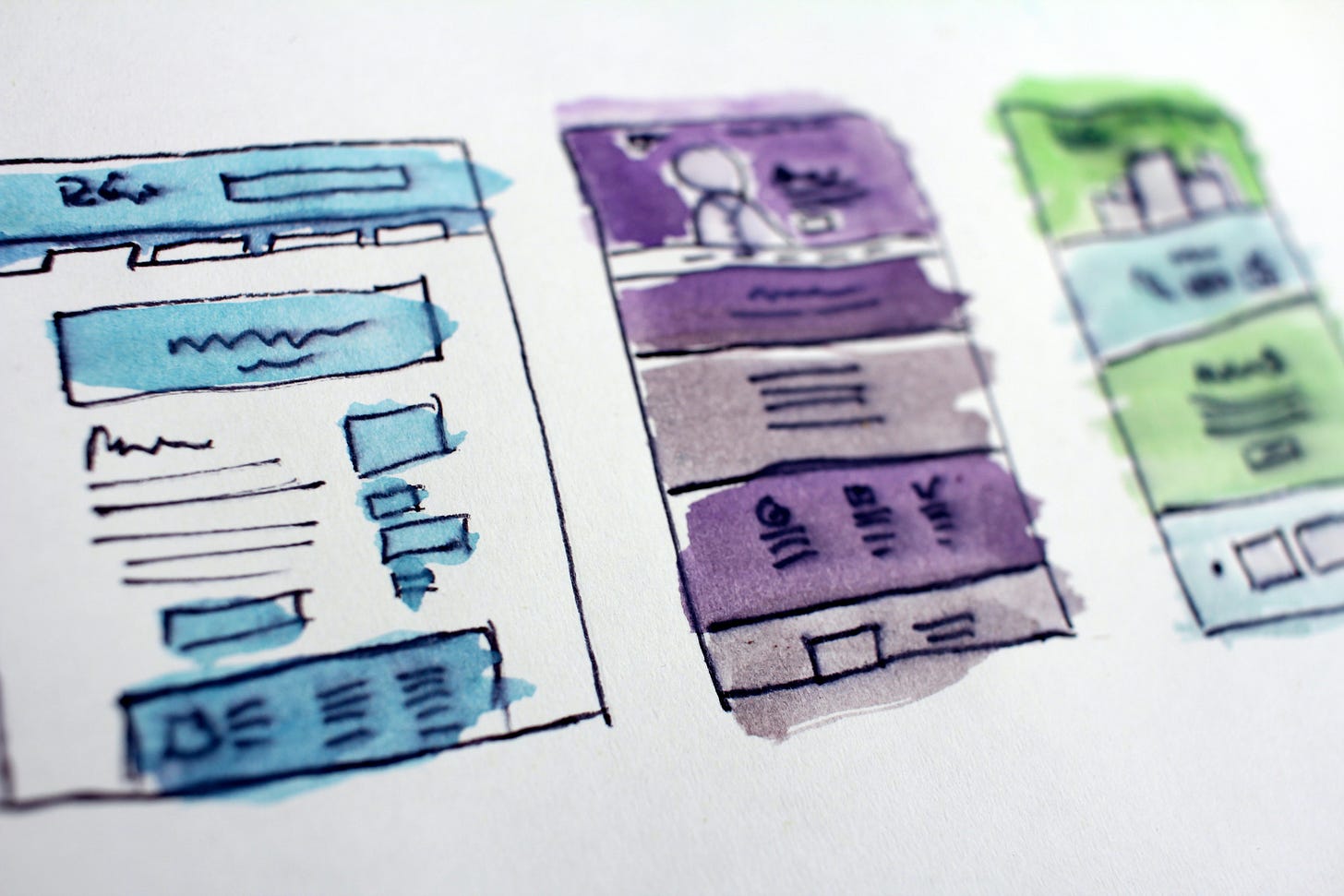 Watercolor boxes with scribbles in them that look like plans or layouts of websites