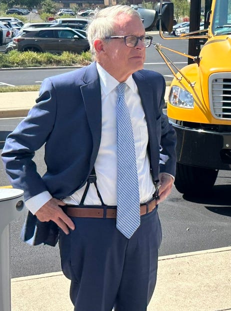 Governor Mike DeWine wearing suspenders and a belt during a photo op