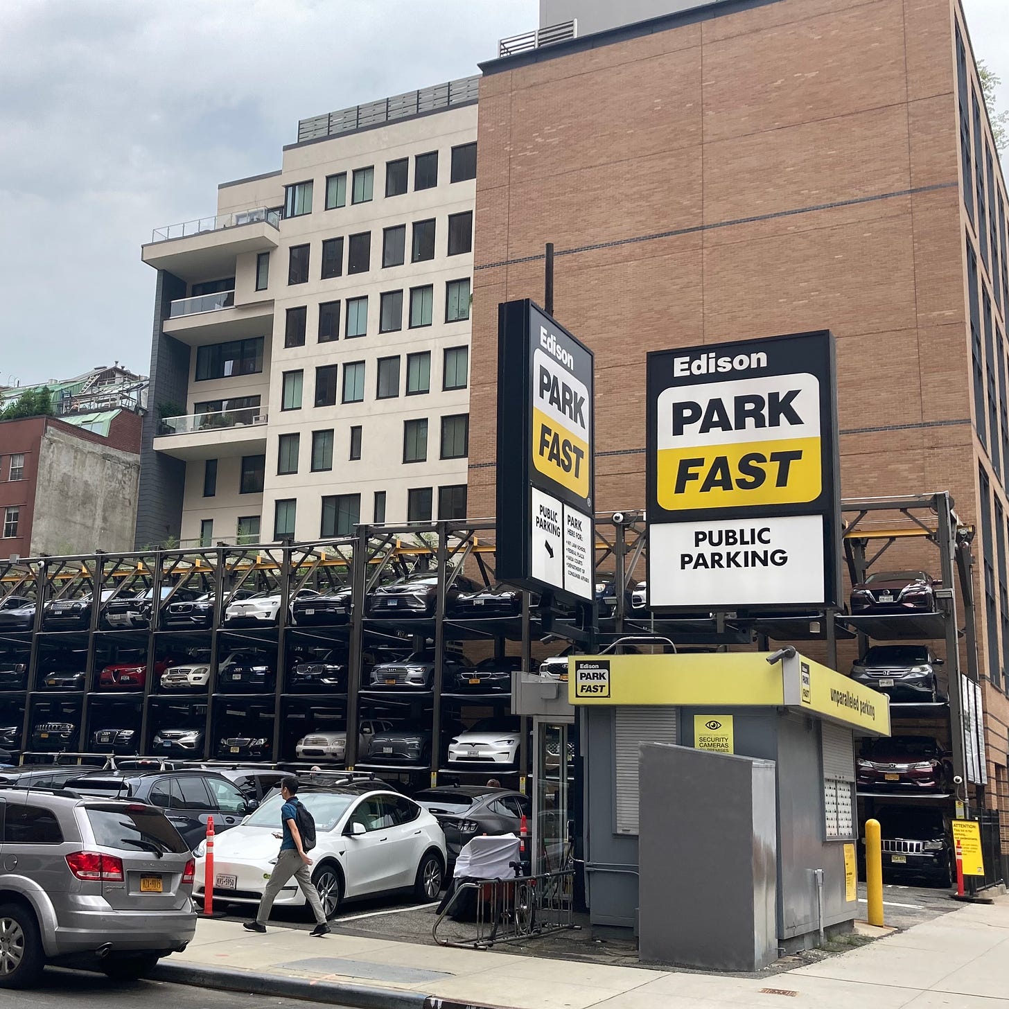 public parking lot with cars stacked in four rows