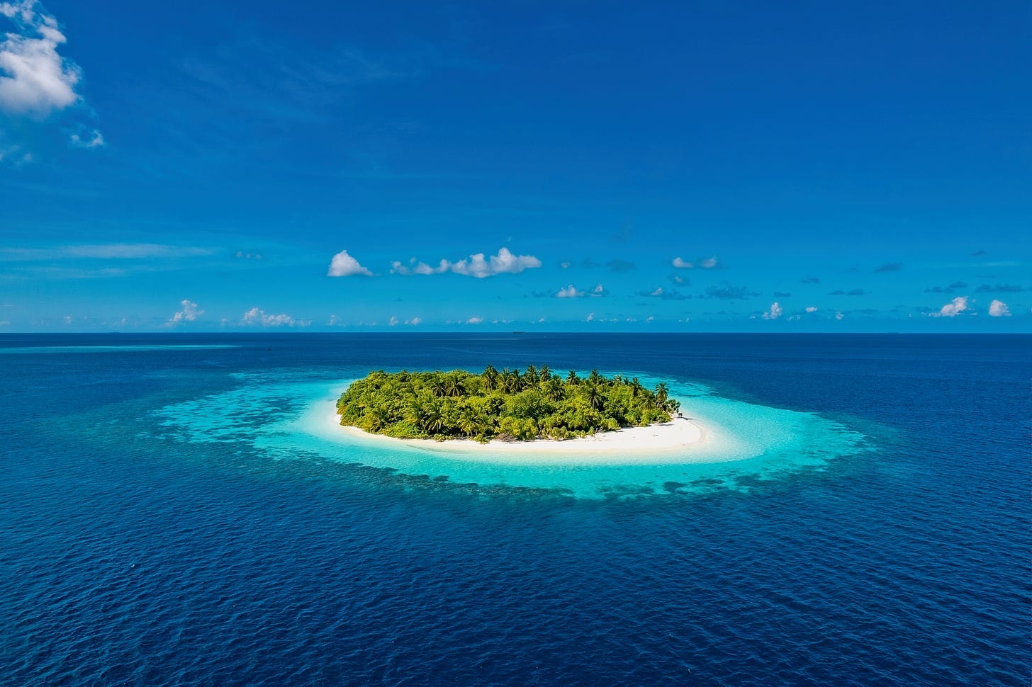 Isolated tropical island in blue ocean