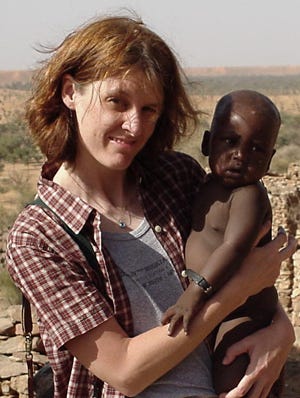 Kirsten Lyke, MD holds child in Burkino Faso. Kirsten Lyke, MD holds child in Burkino Faso.