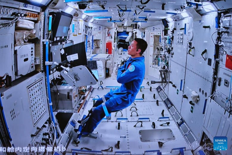 Li Cong inside Tianhe monitoring the spacewalk. (Via Xinhua)