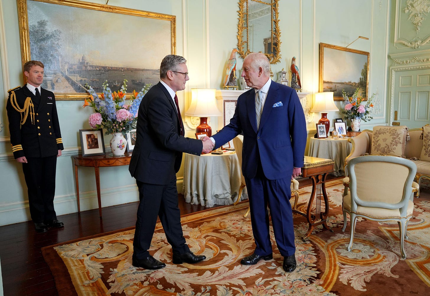 King Charles shakes hands with Keir Starmer