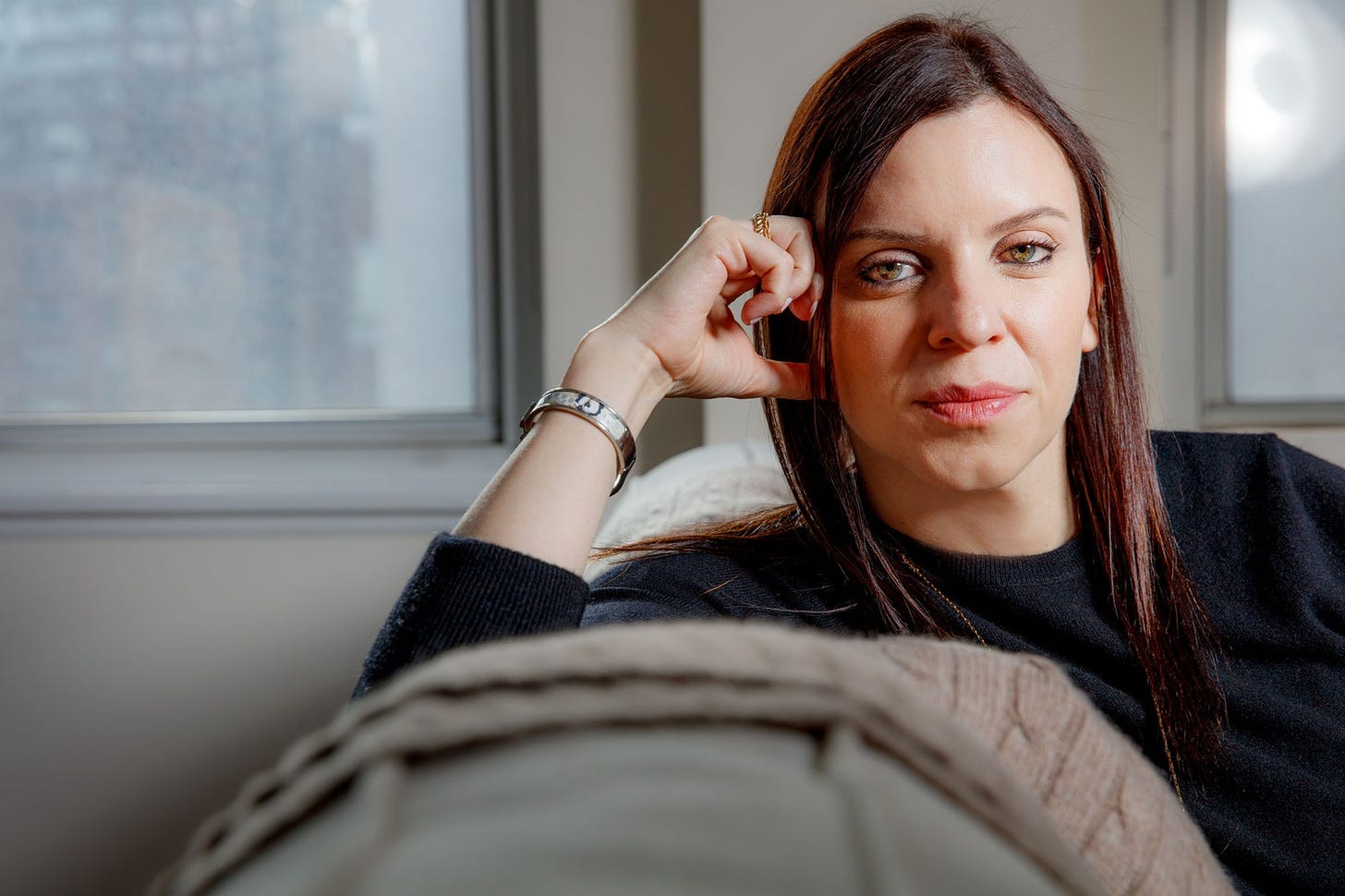 Marina Hadjipateras woman on couch in apartment