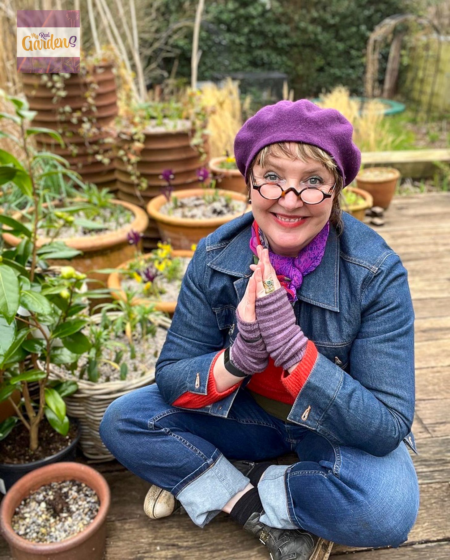 Ann-Marie powell in a purple beret sitting on her garden deck 