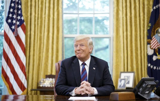 President-elecct Donald Trump smiles during a phone conversation with Mexico's President Enrique Pena Nieto on trade in the Oval Office of the White House in Washington, DC on August 27, 2018 under his first administration. The Ontario government has announced new border security measures designed to prevent illegal border crossings and the smuggling of illegal firearms and drugs. Trump has threatened to implement a 25 percent tariff on all goods from Canada, as well as Mexico, if the country does not clamp down on immigration and the flow of drugs. The move by the Ontario government suggests Trump's effort to strongarm Canada into enforcing tougher border security appears to be working. . MANDEL NGAN/AFP via Getty Images