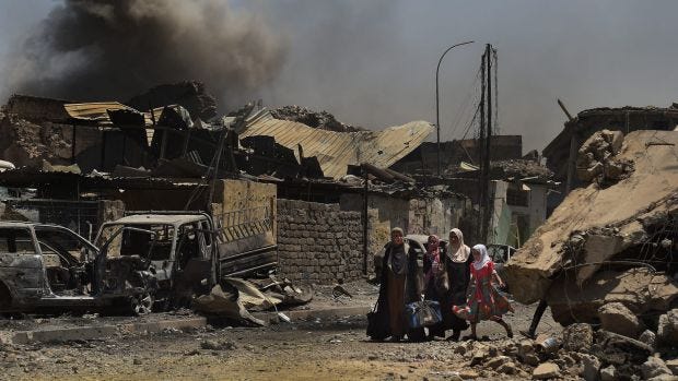 People flee the last of the Islamic State-held areas in West Mosul.