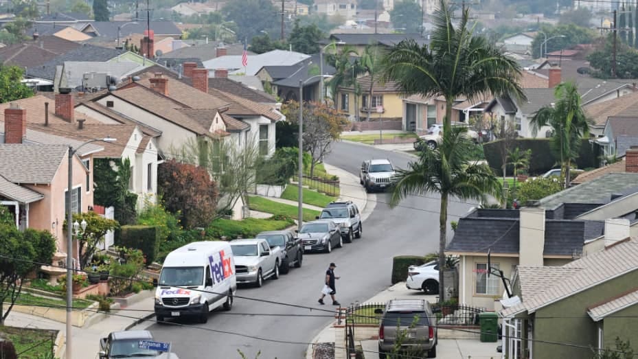 A delivery man delivers packages in a Los Angeles neighborhood on January 17, 2024. Southern California home prices dipped from October to November 2023, the first decline in nine months. The average home price in the six-county region clocked in at $829,557 in November, down 0.1% from October, according to data released by Zillow on December 2023. According to the California Association of Realtors, only 11% of households in both Los Angeles County and Orange County could afford a median-priced house durin