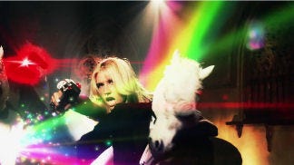 Kesha shooting rainbows at unicorns in "Blow"