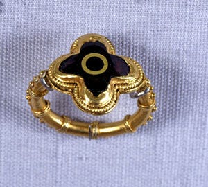 Gold quatrefoil ring with garnet.