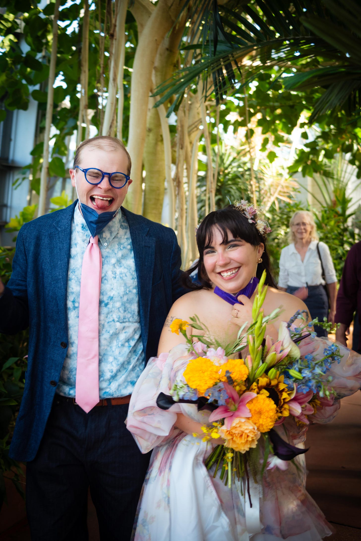 Daniella and Joe making silly faces while taking wedding photos at Garfield Park Conservatory.