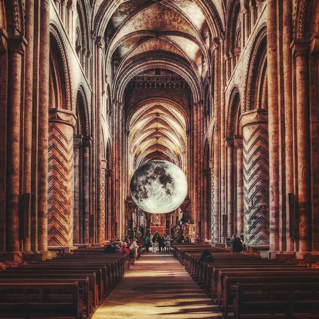 a large cathedral with rows of pews and arches