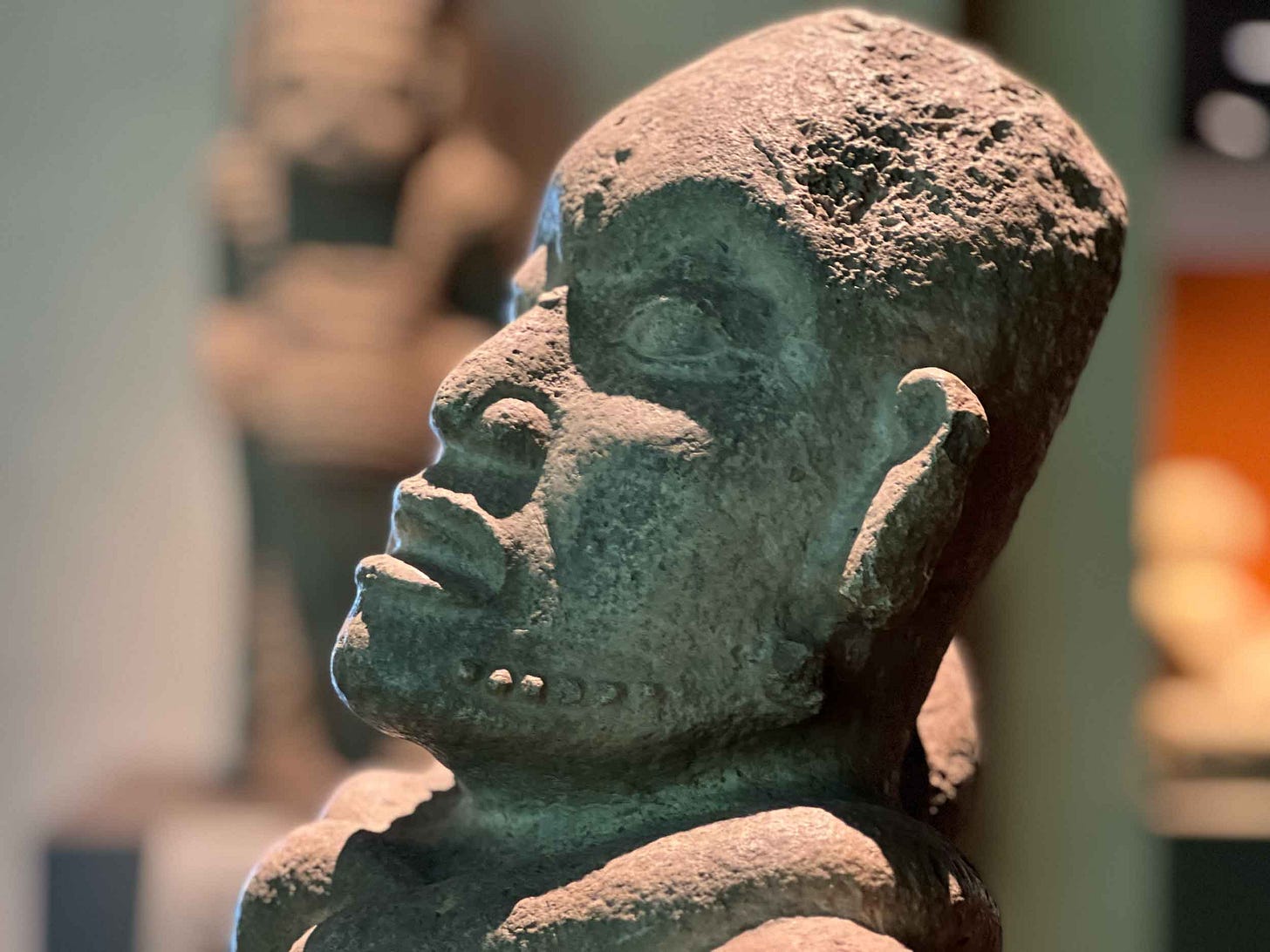 A sculpted head of a life-sized figure in the Maya gallery