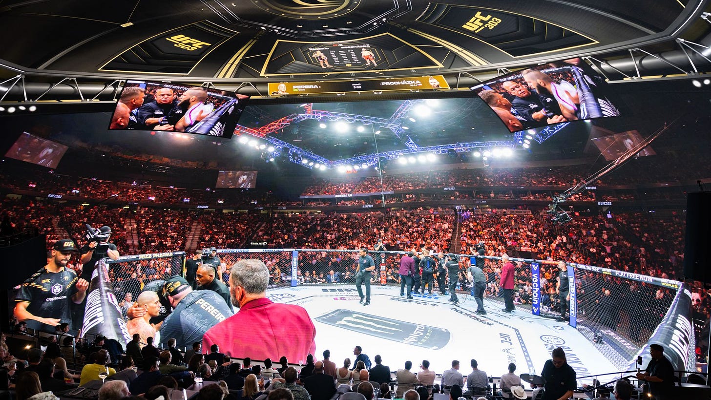 Spectators watching UFC on a dome at Cosm.