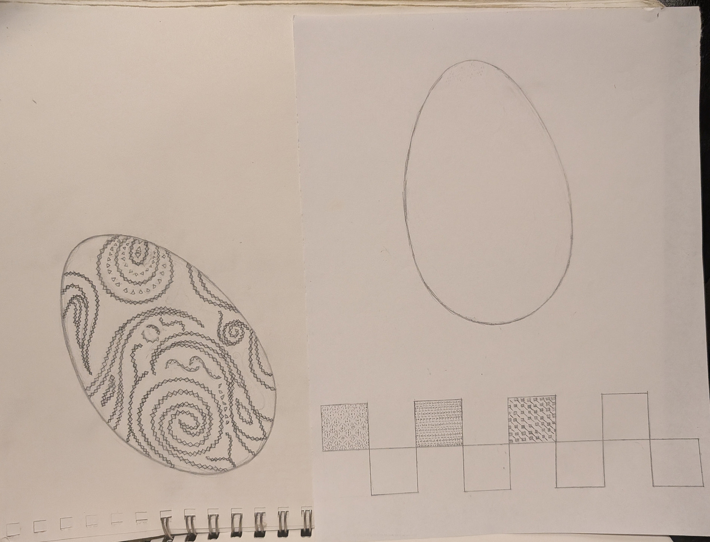 A sketchbook with a drawing of an egg, covered in elaborate designs, with a second sheet of paper, showing a blank egg and several patterns in boxes A sketchbook with a drawing of an egg, covered in elaborate designs, with a second sheet of paper, showing a blank egg and several patterns in boxes