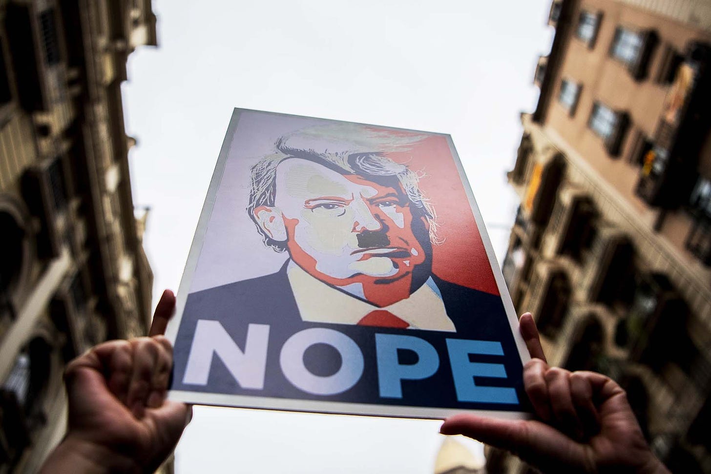 Demonstrators hold posters of U.S. President Donald Trump depicted as Adolf Hitler during the Women's March in Barcelona on Jan. 21.