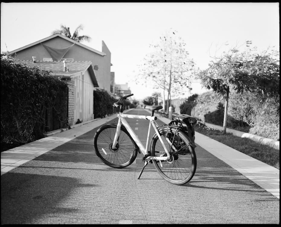 Free Grayscale Photo of a Bicycle on Road  Stock Photo