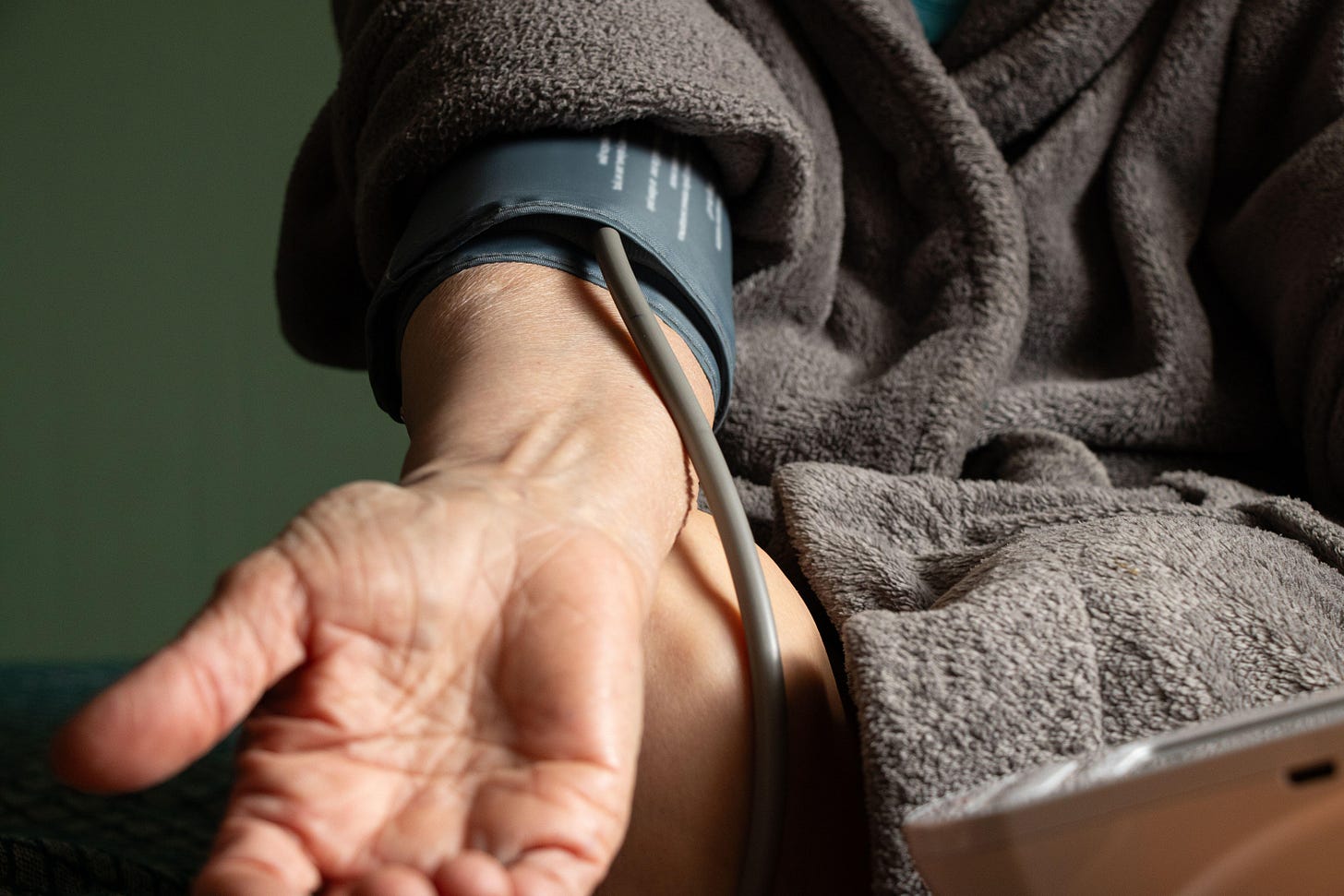 Elderly woman measures blood pressure with a tonometer at home, blood pressure measurements, high blood pressure