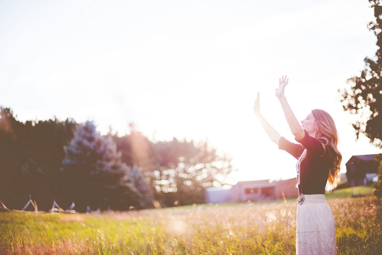 Woman worshiping God in a field