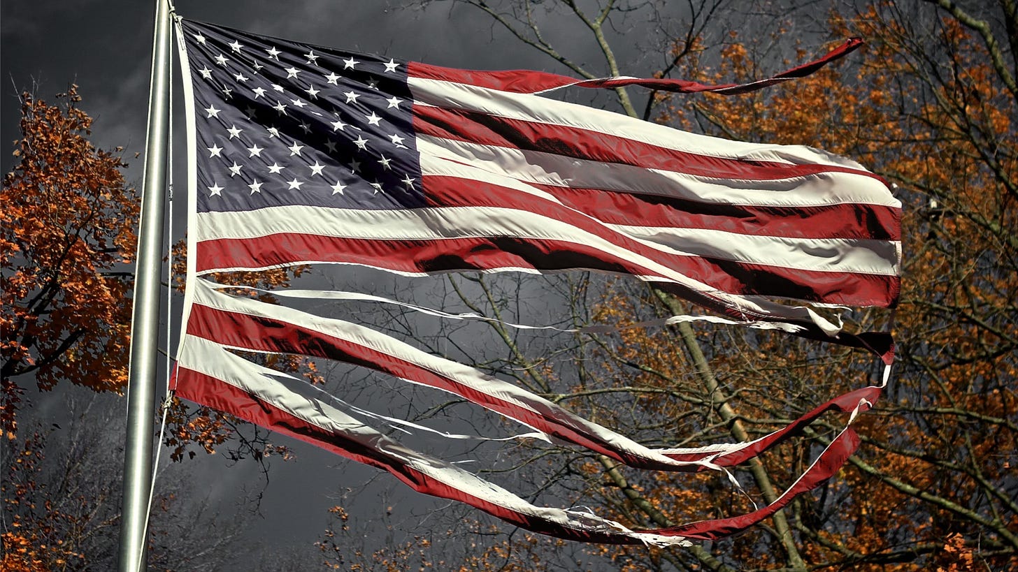 A tattered US flag blowing in the wind